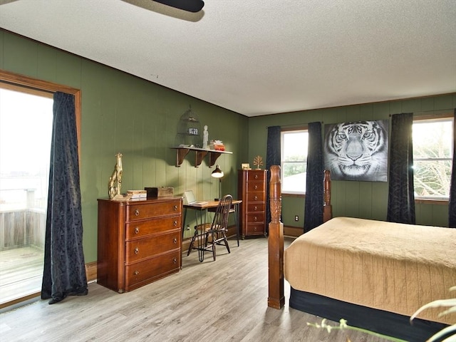 bedroom with wood-type flooring and a textured ceiling