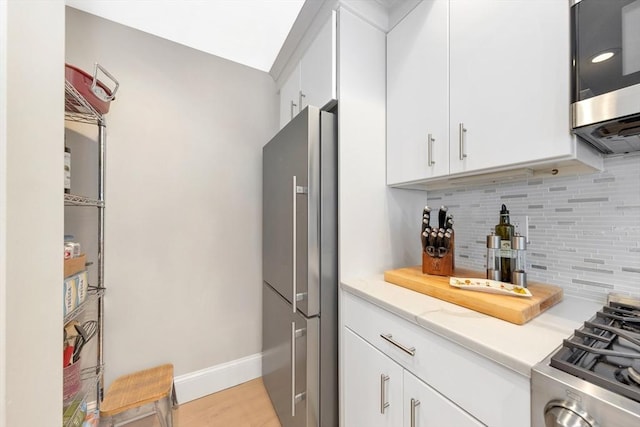 600 Shirley St Unit 3, Winthrop, MA 02152 - kitchen with appliances with stainless steel finishes, tasteful backsplash, baseboards, and white cabinetry