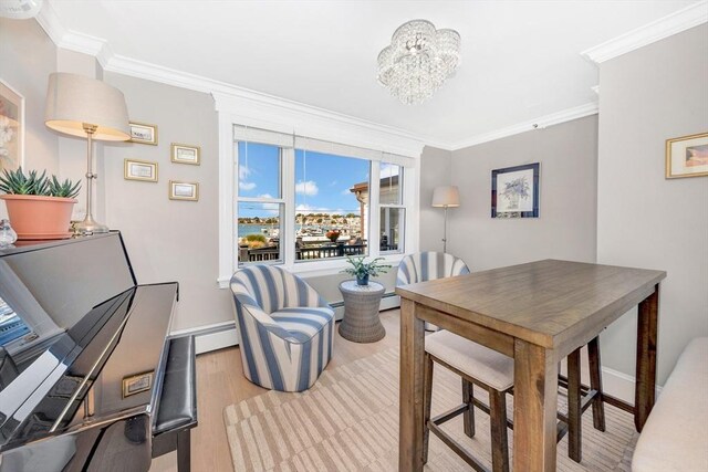 600 Shirley St Unit 3, Winthrop, MA 02152 - dining space with ornamental molding, wood finished floors, baseboards, a chandelier, and baseboard heating