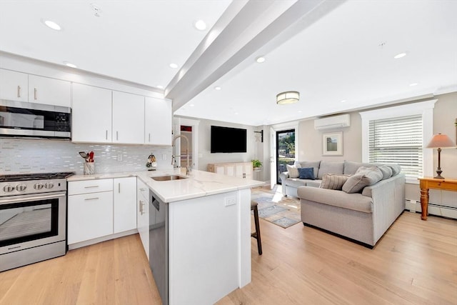 600 Shirley St Unit 3, Winthrop, MA 02152 - kitchen featuring appliances with stainless steel finishes, a wall mounted air conditioner, a sink, a peninsula, and open floor plan