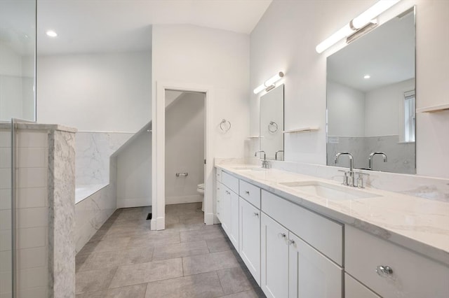 26 Newport St Unit 2, Boston, MA 02125 - bathroom featuring toilet, double vanity, a bathtub, tile patterned floors, and recessed lighting