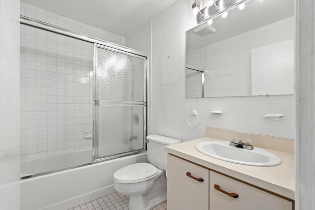 full bathroom with tile patterned floors, toilet, vanity, and enclosed tub / shower combo