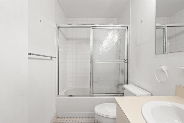 full bathroom with tile patterned floors, vanity, toilet, and enclosed tub / shower combo