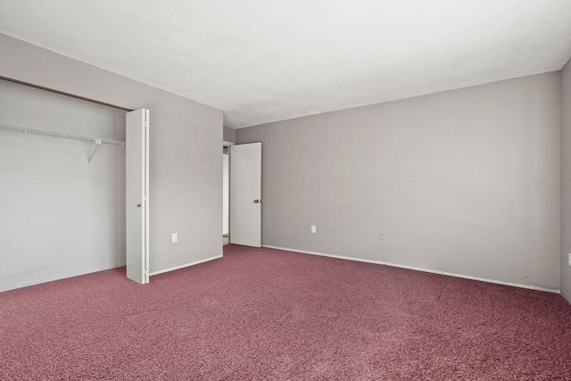 unfurnished bedroom featuring carpet floors and a closet