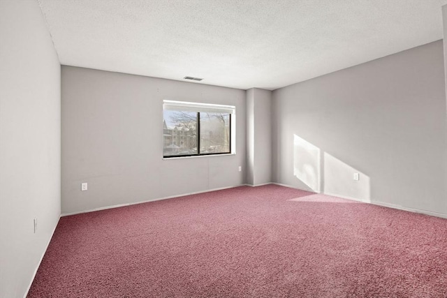 unfurnished room featuring carpet floors and a textured ceiling