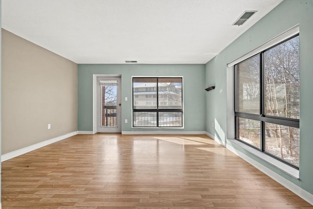 unfurnished room with light hardwood / wood-style flooring