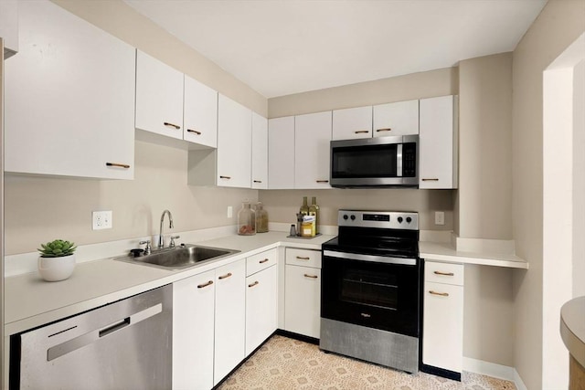 kitchen featuring appliances with stainless steel finishes, sink, and white cabinetry