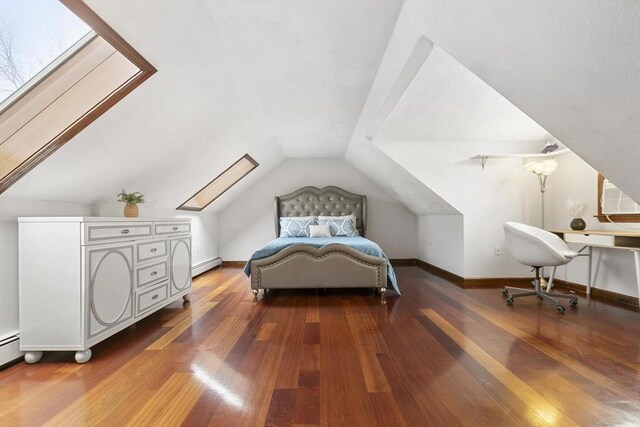 bedroom featuring lofted ceiling with skylight, a baseboard radiator, hardwood / wood-style flooring, and baseboards