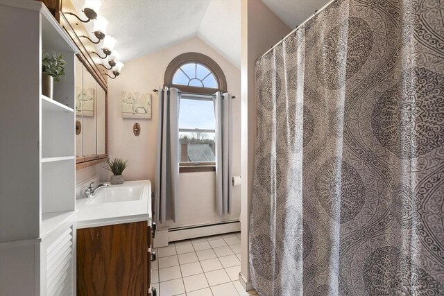 bathroom featuring a baseboard radiator, vaulted ceiling, vanity, and tile patterned floors