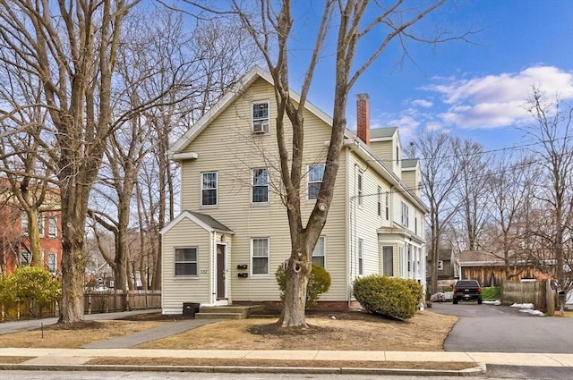 view of front of property featuring fence and a chimney