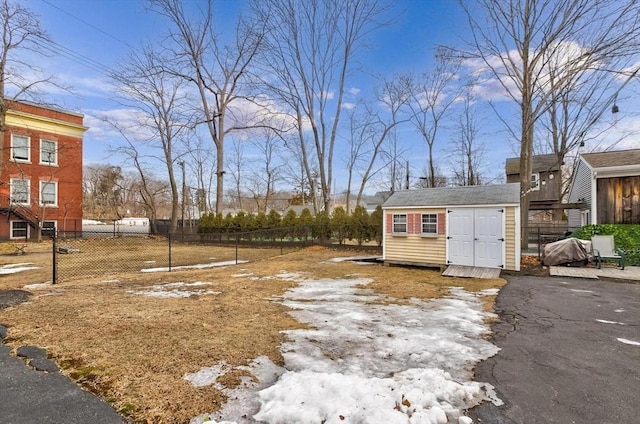 view of yard featuring a storage unit, fence, and an outdoor structure