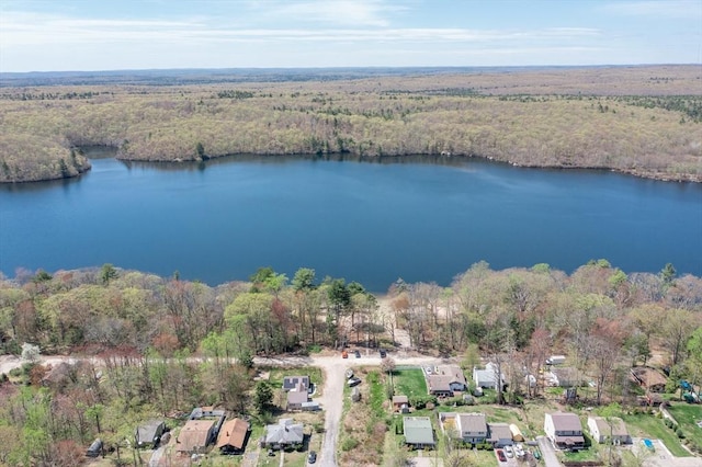birds eye view of property featuring a water view and a wooded view