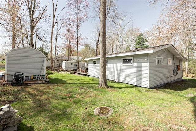 view of yard with a storage shed and an outbuilding
