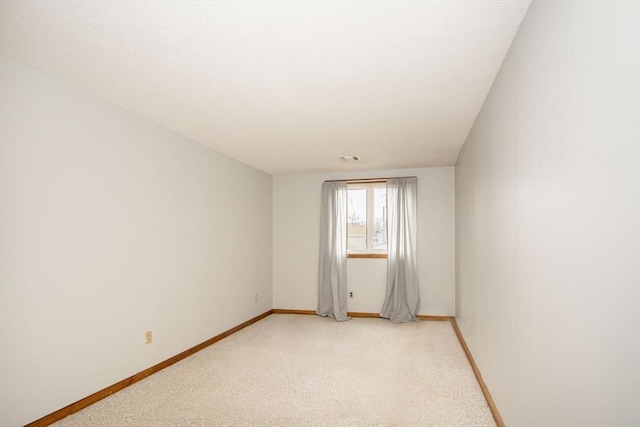 empty room featuring light colored carpet