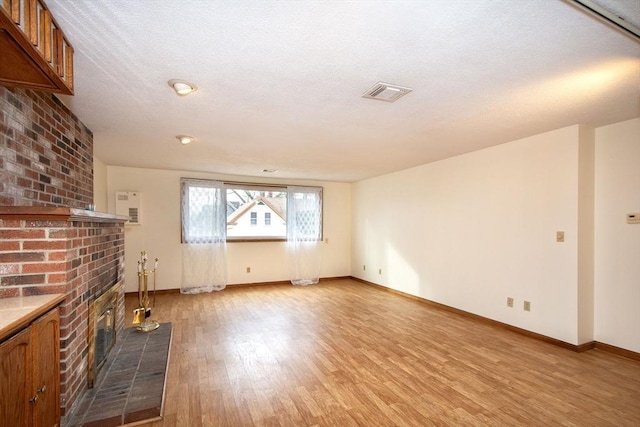 unfurnished living room featuring light wood-type flooring and a fireplace