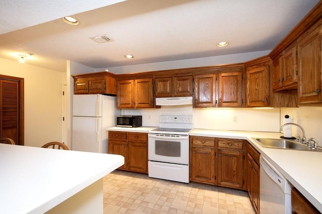 kitchen featuring sink and white appliances