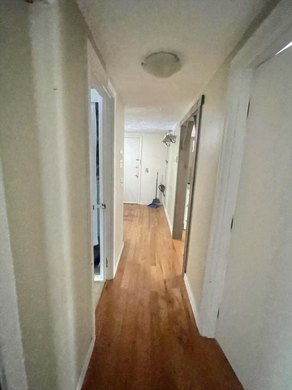 corridor with light hardwood / wood-style floors