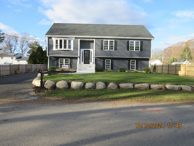 split foyer home with a front lawn