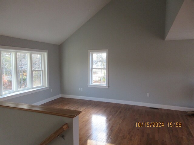 unfurnished room with wood-type flooring and vaulted ceiling