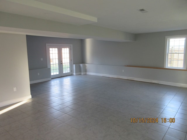 unfurnished room featuring french doors and light tile patterned floors