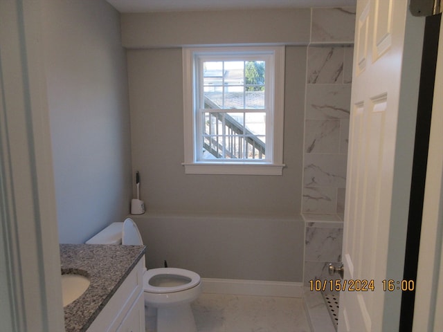 bathroom with vanity, toilet, and a tile shower