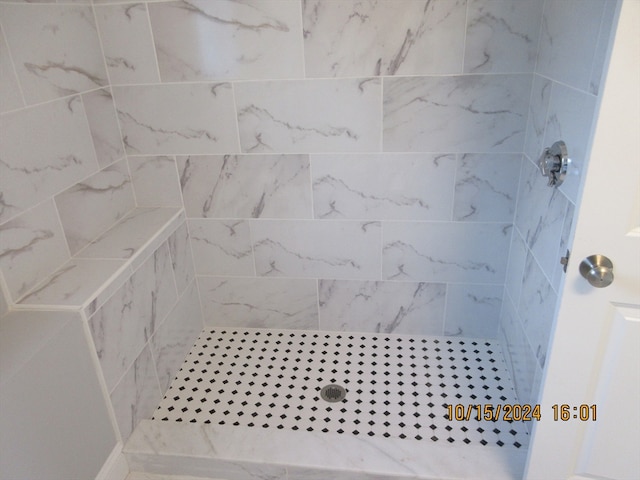 bathroom with a tile shower