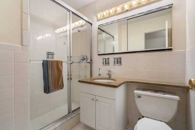 151 Tremont St Unit 9N, Boston, MA 02111 - bathroom with tile walls, a stall shower, and vanity