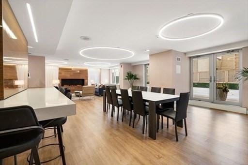 151 Tremont St Unit 9N, Boston, MA 02111 - dining area with wood finished floors and a fireplace