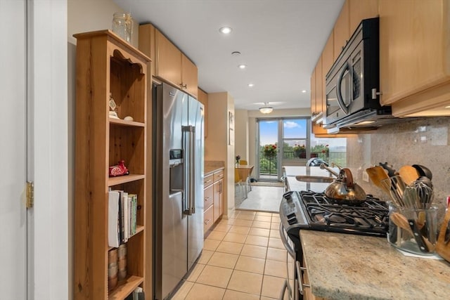 151 Tremont St Unit 9N, Boston, MA 02111 - kitchen featuring appliances with stainless steel finishes, light tile patterned floors, decorative backsplash, open shelves, and light brown cabinets