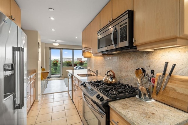151 Tremont St Unit 9N, Boston, MA 02111 - kitchen with appliances with stainless steel finishes, light tile patterned floors, backsplash, recessed lighting, and light stone countertops