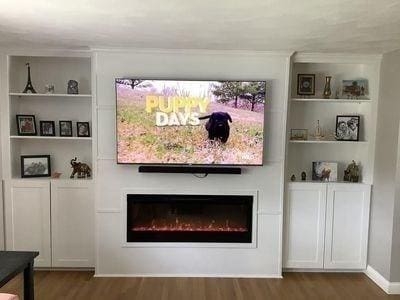 15 Northside Ct, Haverhill, MA 01830 - living room featuring a warm lit fireplace, wood finished floors, and built in shelves