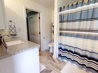 15 Northside Ct, Haverhill, MA 01830 - full bathroom featuring vanity, marble finish floors, and curtained shower