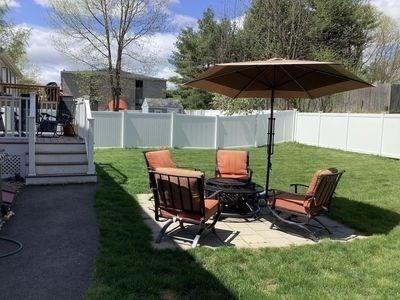 15 Northside Ct, Haverhill, MA 01830 - fenced backyard with a wooden deck and a patio