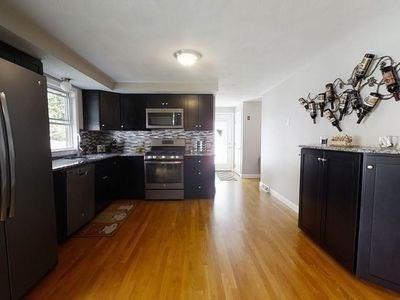 15 Northside Ct, Haverhill, MA 01830 - kitchen with stainless steel appliances, wood finished floors, and decorative backsplash