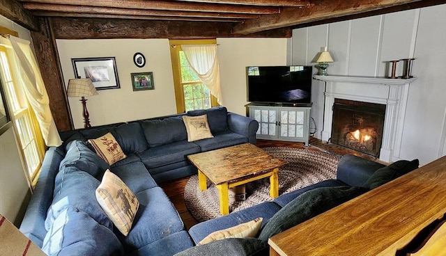 5 Putnam Hill Rd, Sutton, MA 01590 - living area featuring wood finished floors, a lit fireplace, and beamed ceiling