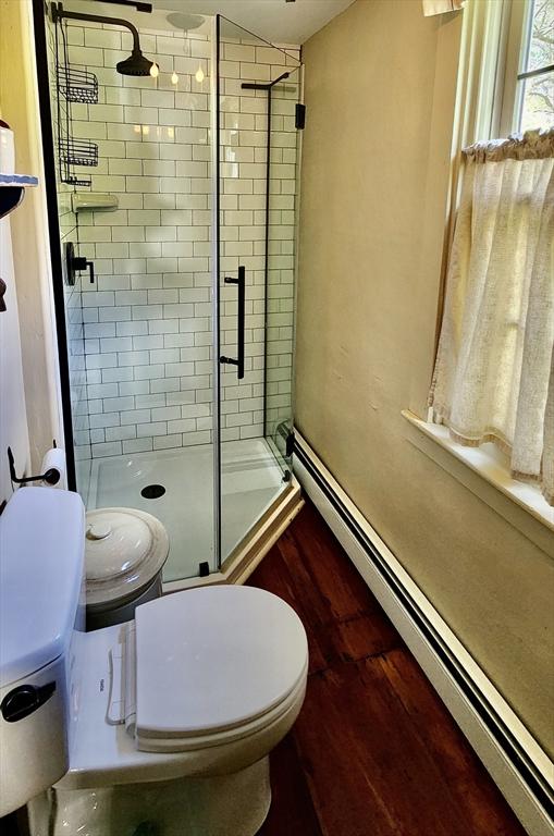 5 Putnam Hill Rd, Sutton, MA 01590 - full bathroom with baseboard heating, toilet, a shower stall, and wood finished floors