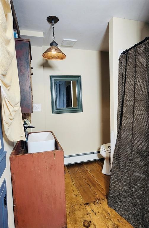 5 Putnam Hill Rd, Sutton, MA 01590 - bathroom with baseboard heating, hardwood / wood-style flooring, toilet, and vanity