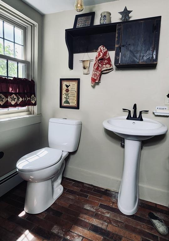 5 Putnam Hill Rd, Sutton, MA 01590 - half bath with toilet, brick flooring, a baseboard heating unit, and baseboards