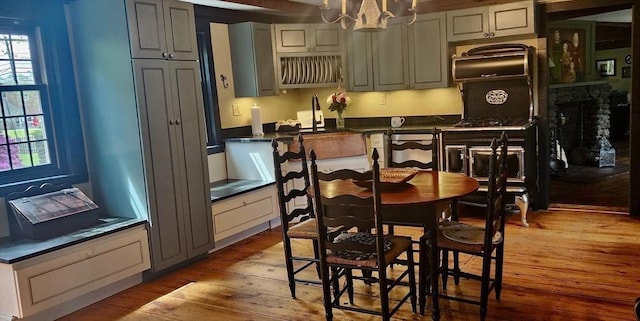 5 Putnam Hill Rd, Sutton, MA 01590 - kitchen featuring dark countertops, light wood-style flooring, a chandelier, hanging light fixtures, and a sink