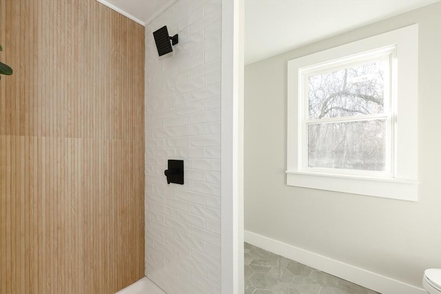 bathroom with tile patterned flooring, toilet, and walk in shower