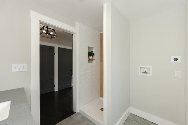 bathroom featuring a shower and vanity