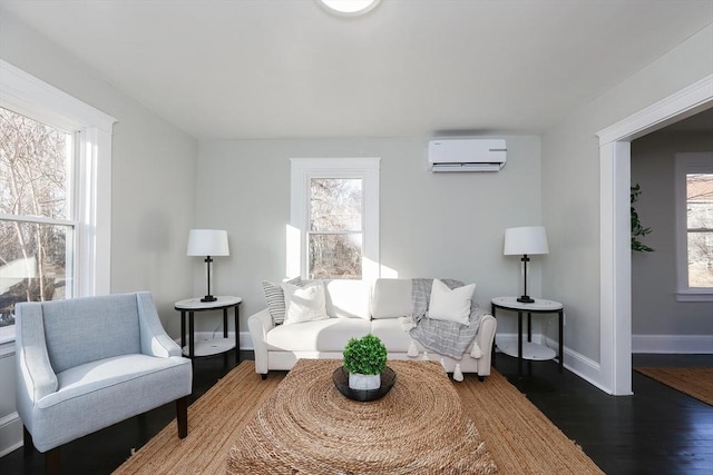 living room with a wall mounted air conditioner and hardwood / wood-style floors