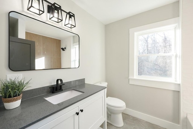 bathroom featuring tile patterned flooring, vanity, and toilet