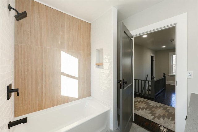 bathroom featuring hardwood / wood-style floors and tile walls