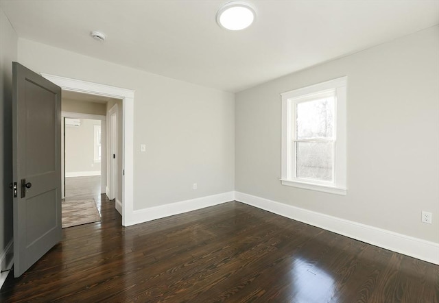 spare room with dark hardwood / wood-style flooring