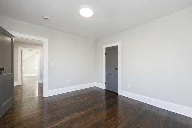 empty room featuring dark hardwood / wood-style flooring