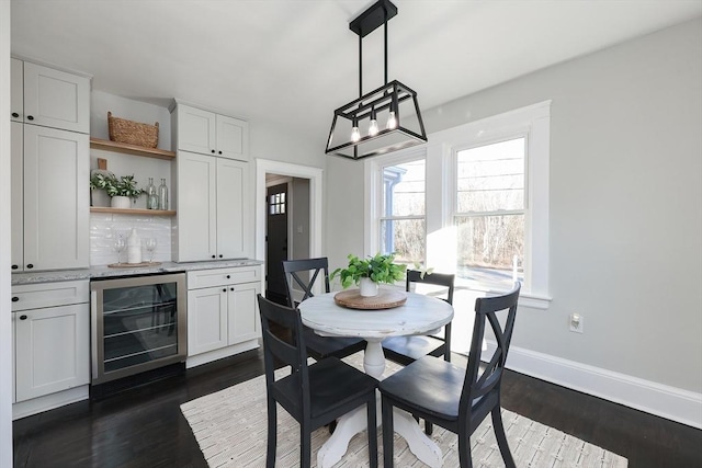 dining area with dark hardwood / wood-style flooring and wine cooler