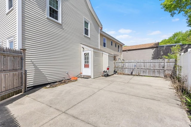 view of side of property with a patio area and a fenced backyard