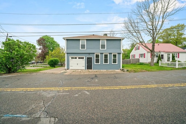 view of front of home featuring fence and driveway