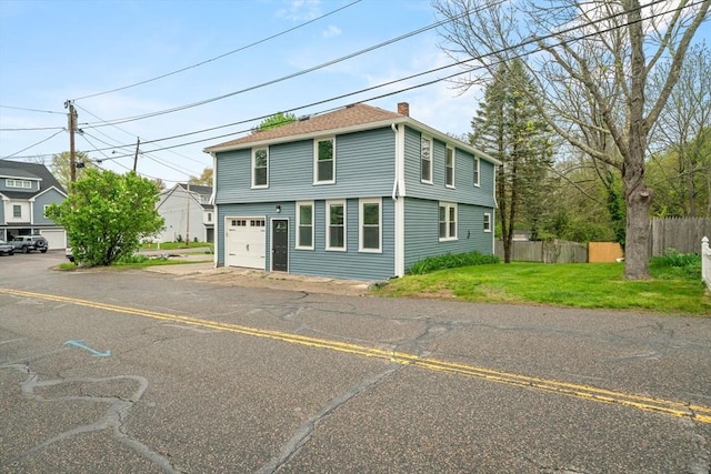 view of front of home featuring a garage and a chimney